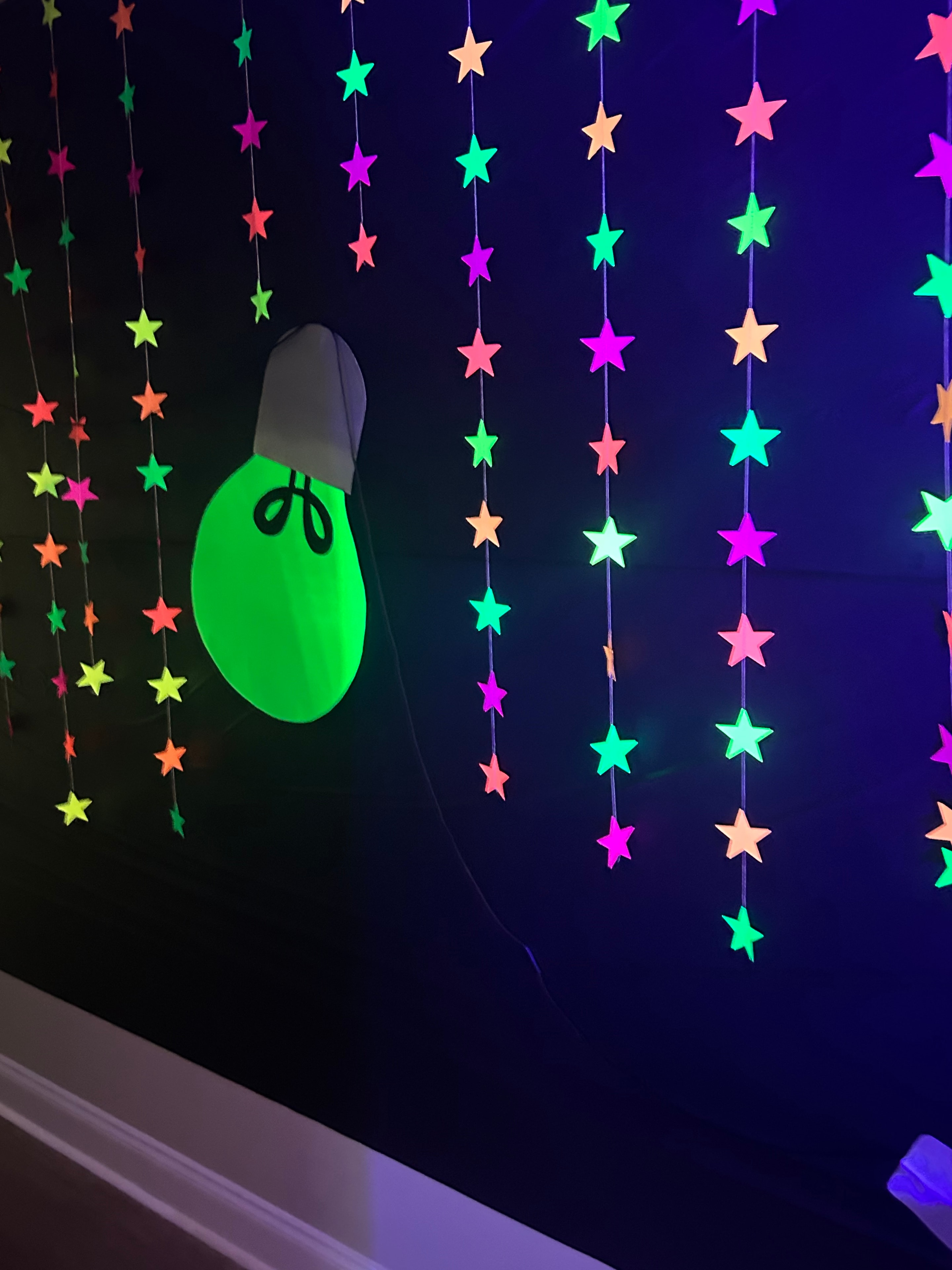 Neon star garland ceiling decorations at VBS 2026 Illumination theme