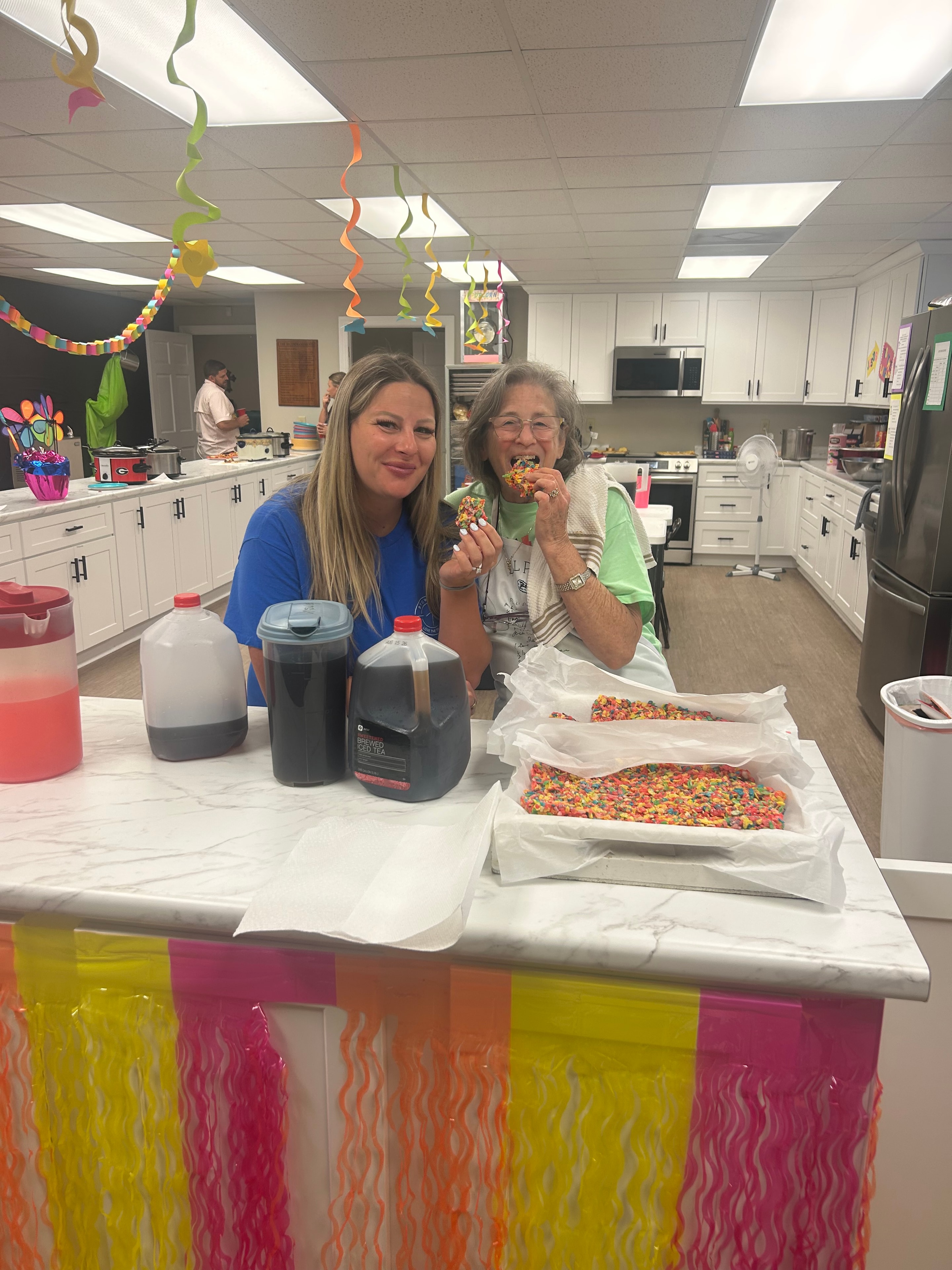 VBS volunteers preparing Fruity Pebbles treats in the kitchen