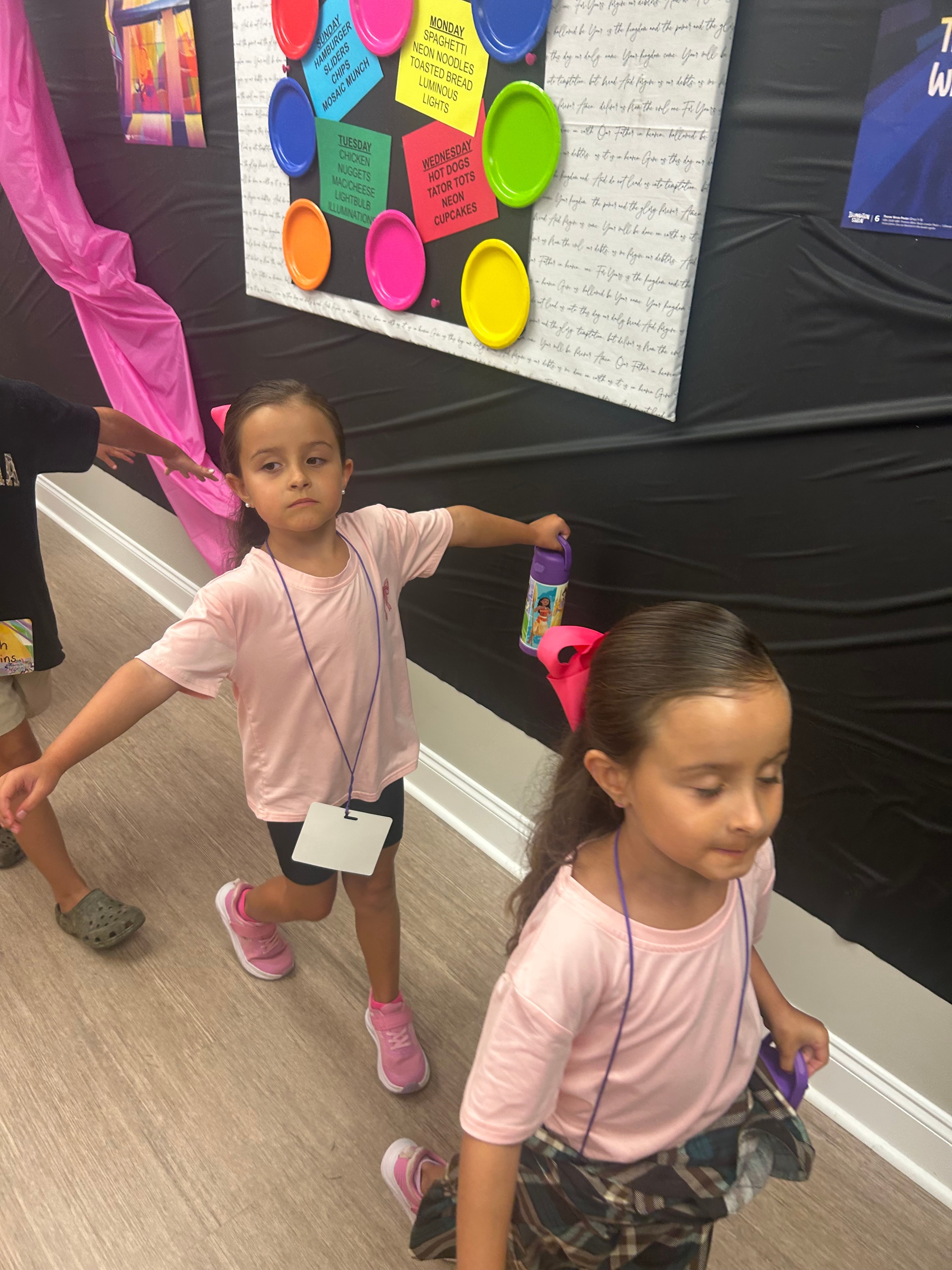 Children at the colorful meal menu board during VBS 2026