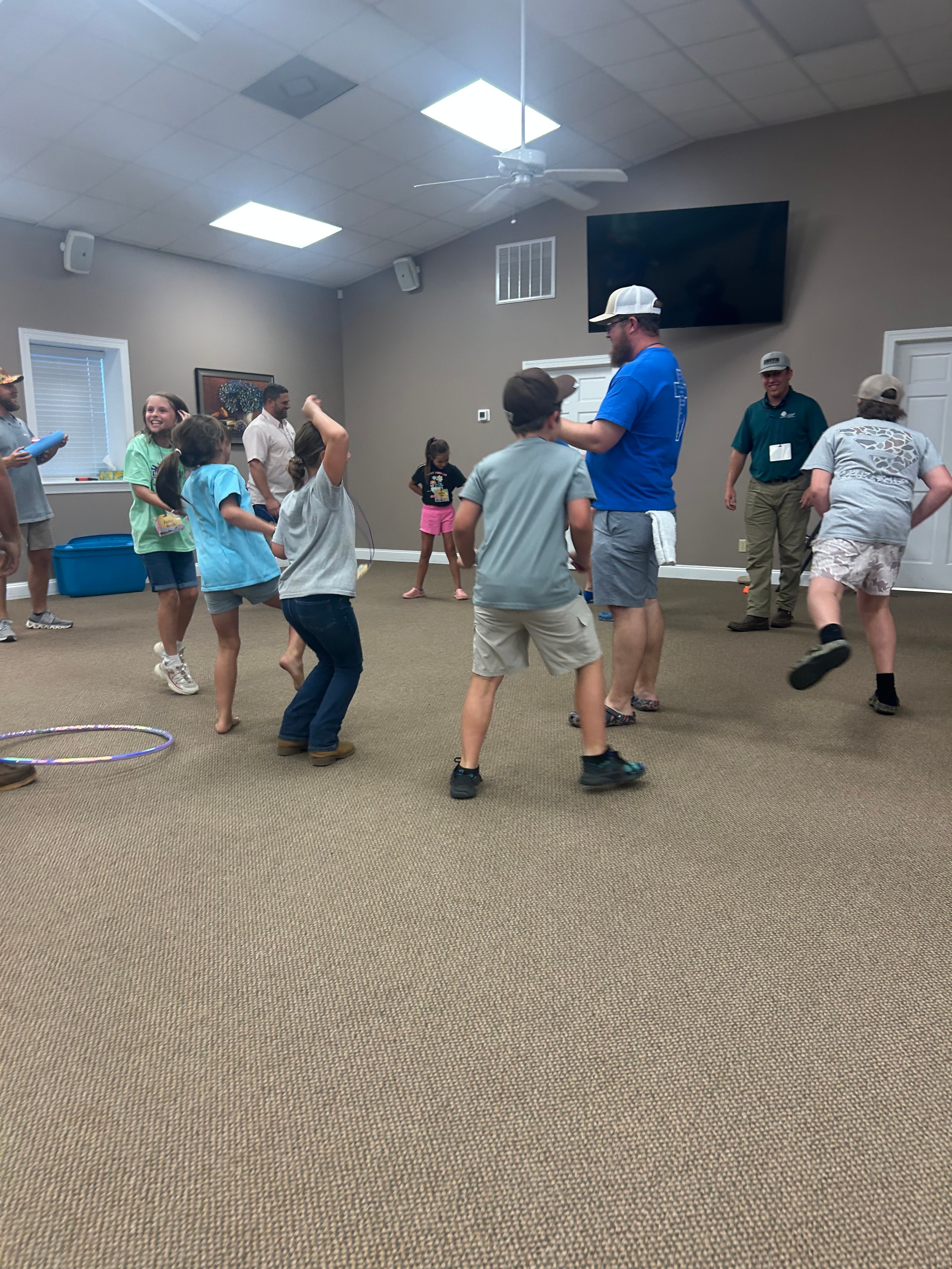 Group of children and adults walking through a room at VBS 2026